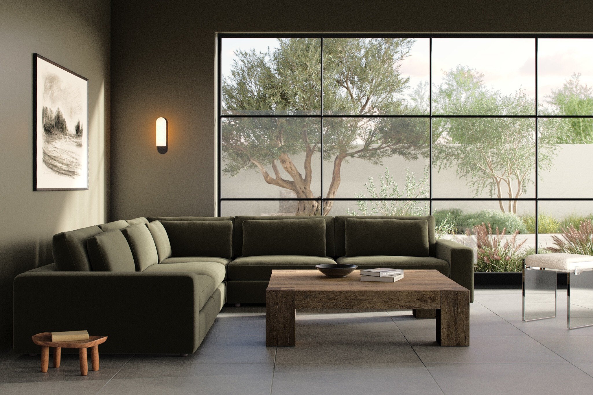 Modern living room with a sectional sofa, coffee table, and large windows.