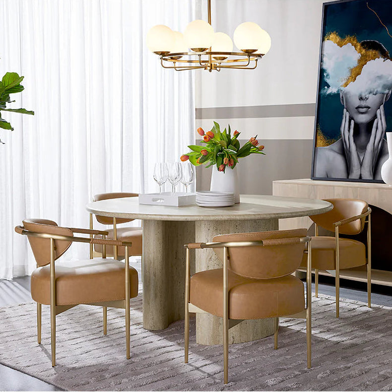 Modern dining room with marble table, chairs, and decorative elements.