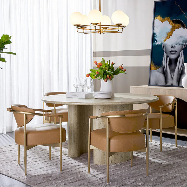 Modern dining room with marble table, chairs, and decorative elements.
