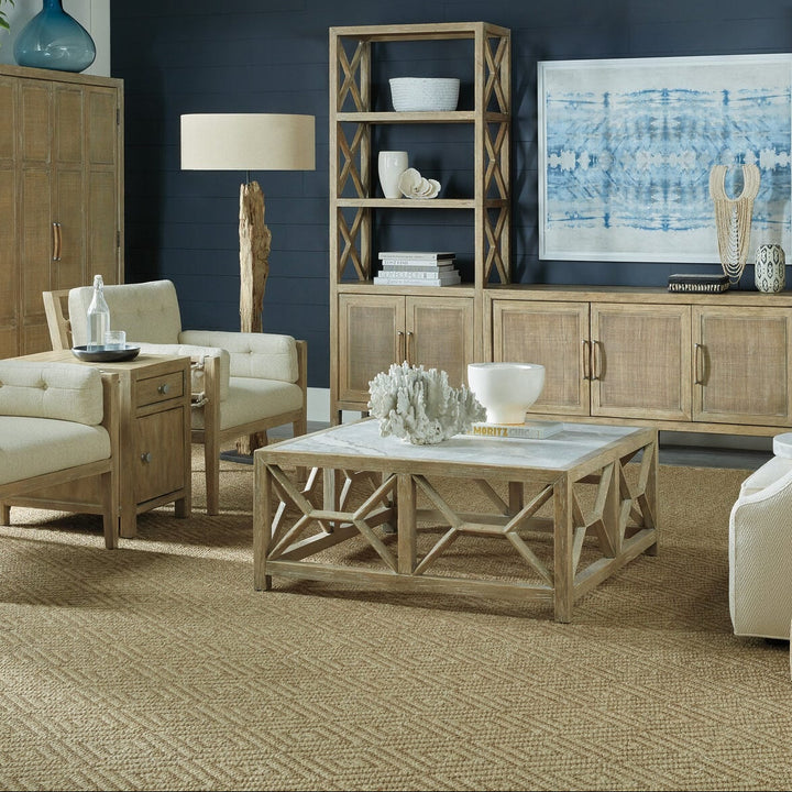 Living room with wooden furniture, white walls, and decorative items.