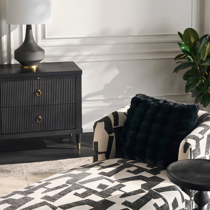 Patterned armchair with a side table in a stylish room setting