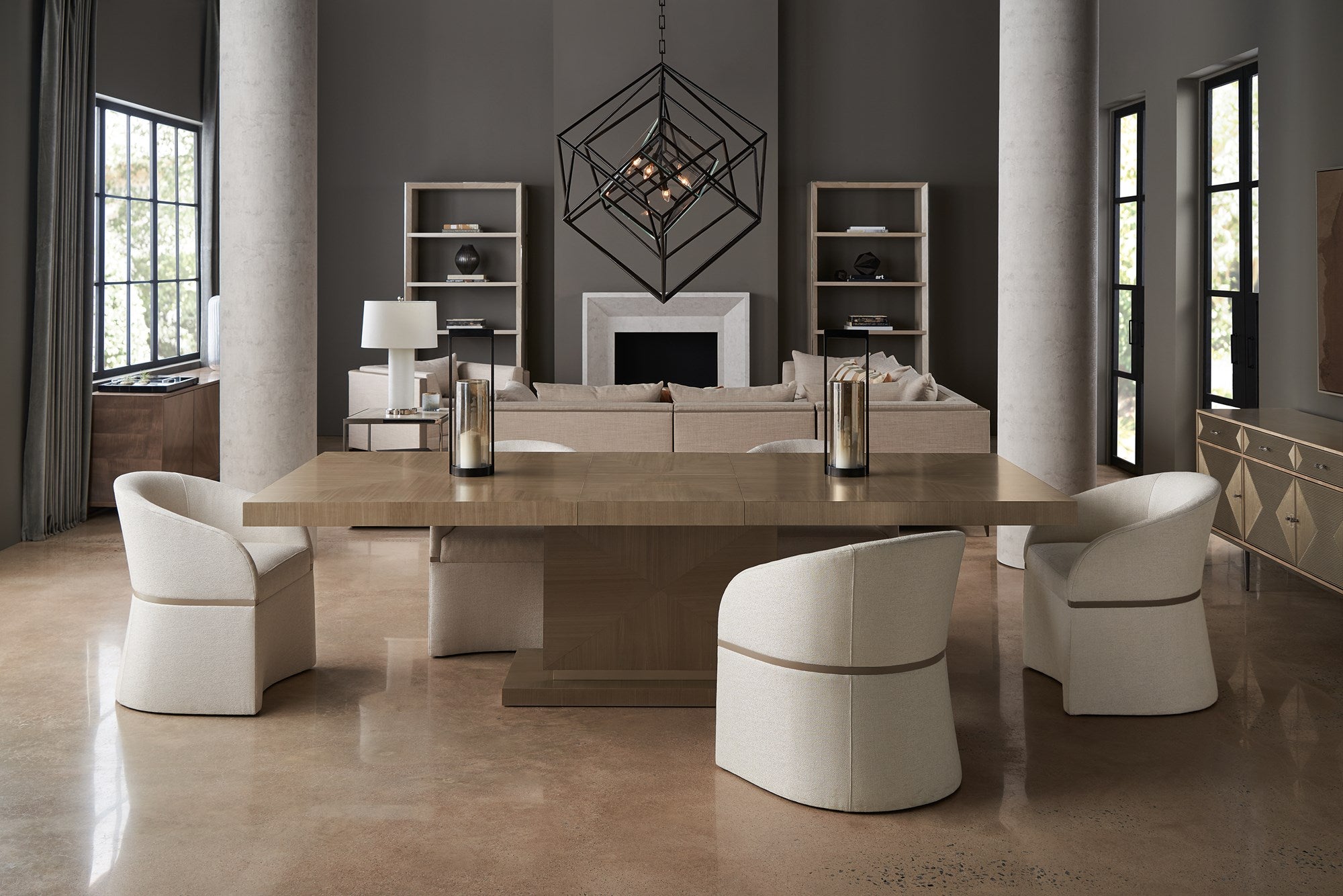 modern open floor plan dining room set with large sectional in the background