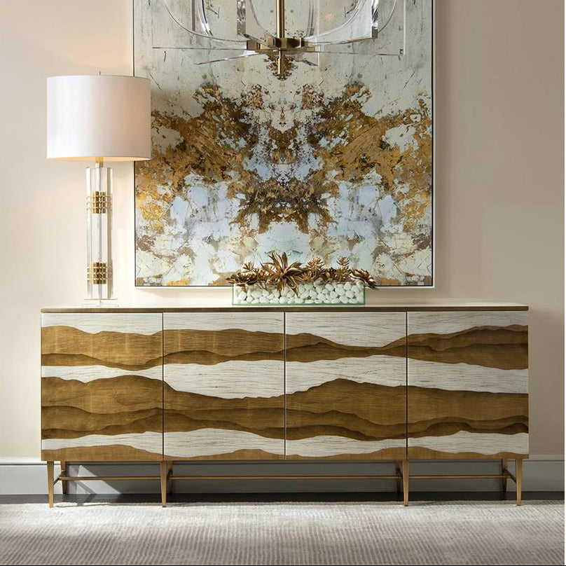 sideboard gold with painting and a lamp