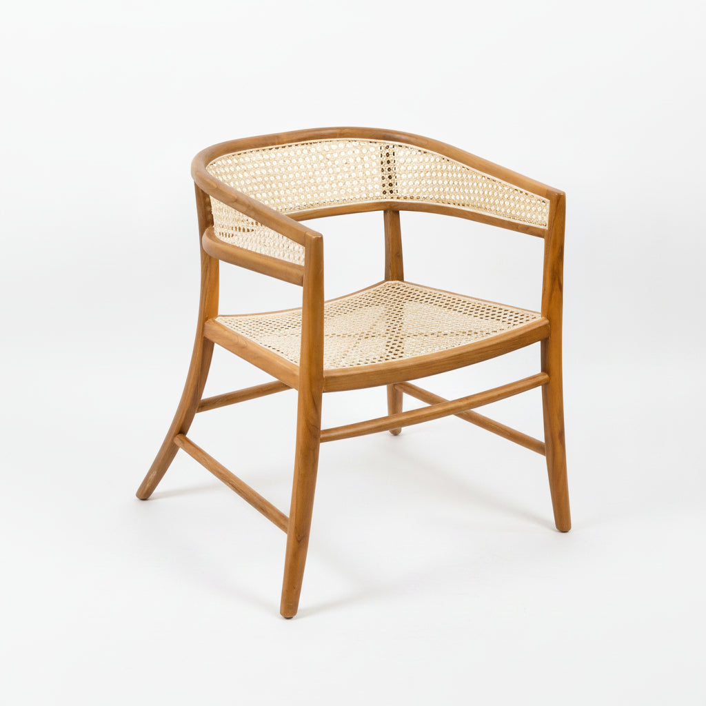 Corner chair with wicker back and seat on a plain background