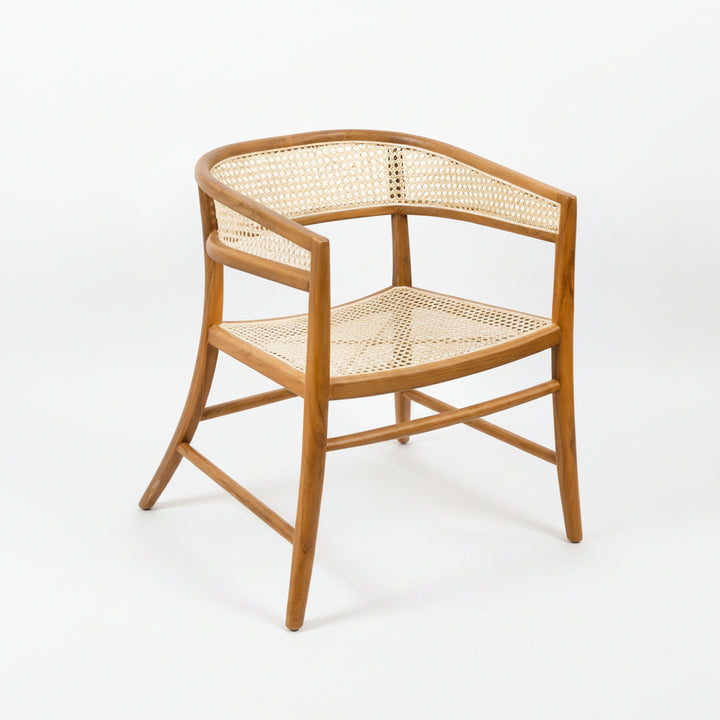 Corner chair with wicker back and seat on a plain background