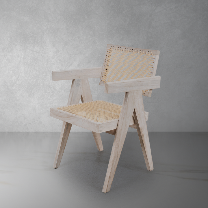 Additional view of Jeanneret Armchair in weathered light grey and natural cane beige, featuring matte finish and fixed arms.