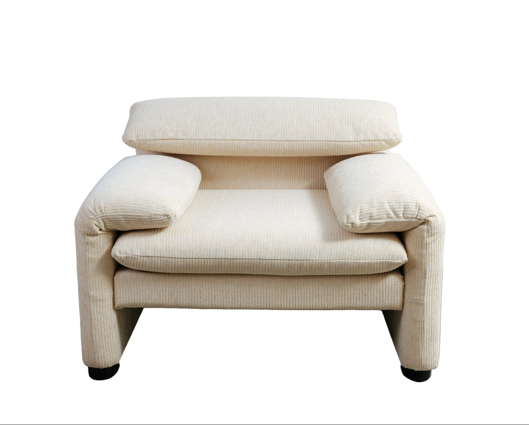 Beige armchair on a gray floor with a white wall background