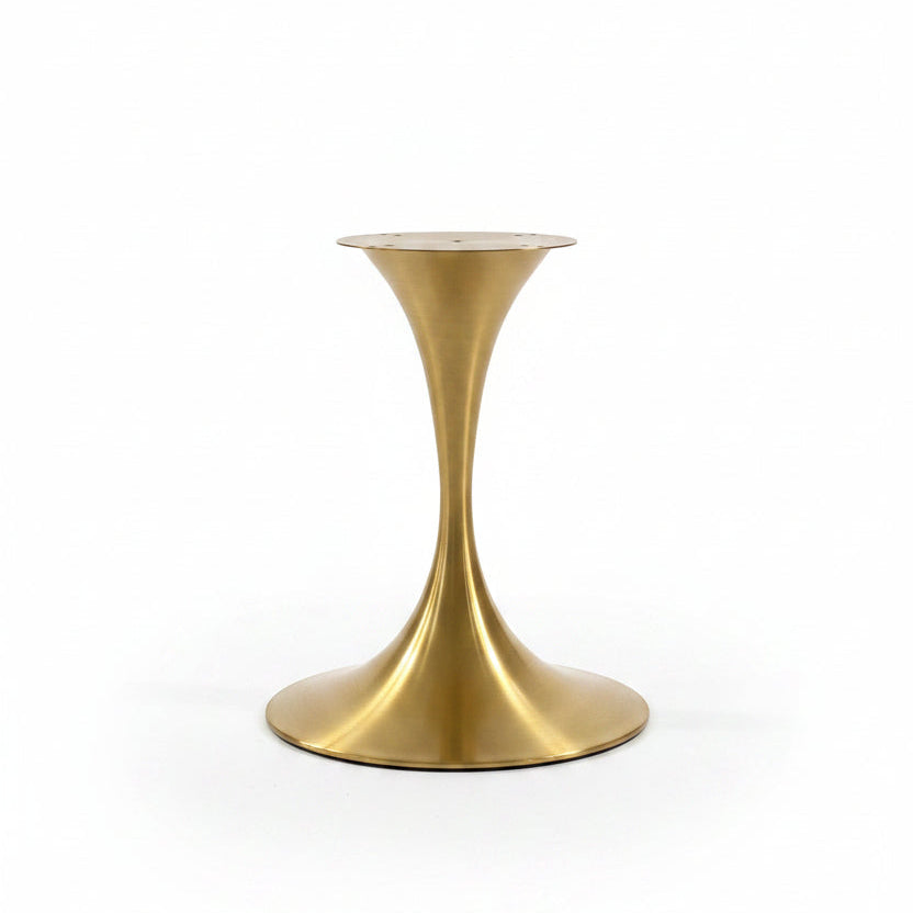 A modern tulip-style side table base in brushed brass, featuring a flared circular top and a curved, tapered pedestal base, set against a plain white background.