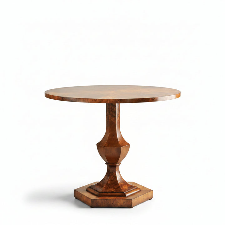 Wooden pedestal table in a room with decorative columns and marble floor.