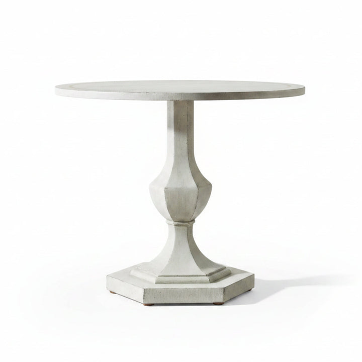 Round decorative table with a pedestal base in a room setting