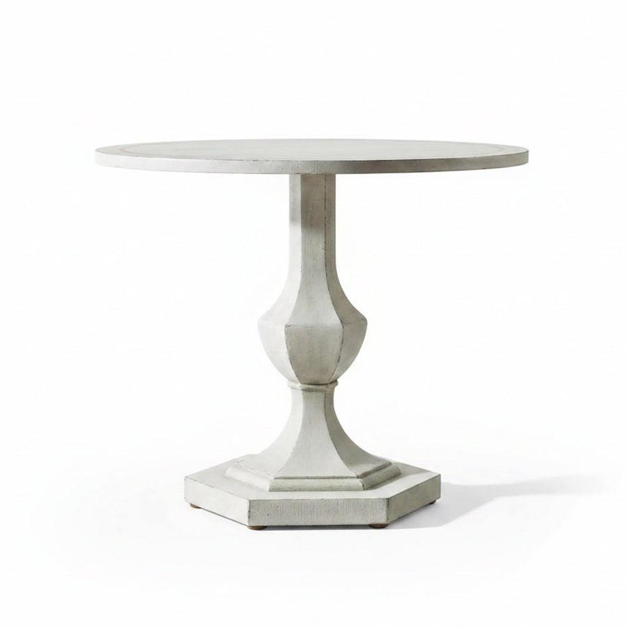 Round decorative table with a pedestal base in a room setting