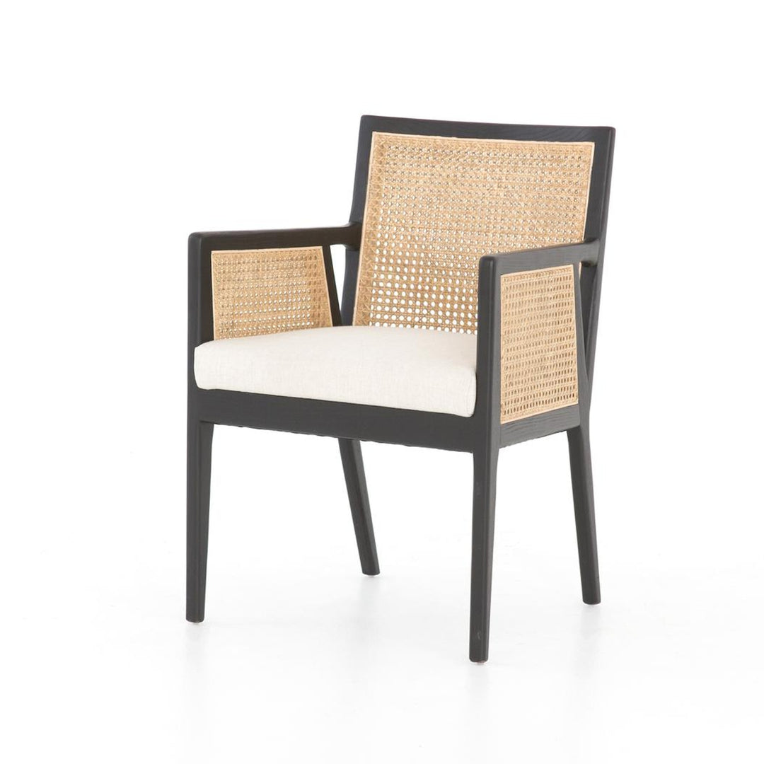 Four Hands Antonia Cane Dining Arm Chair with brushed ebony wood frame, natural cane and neutral upholstered seat