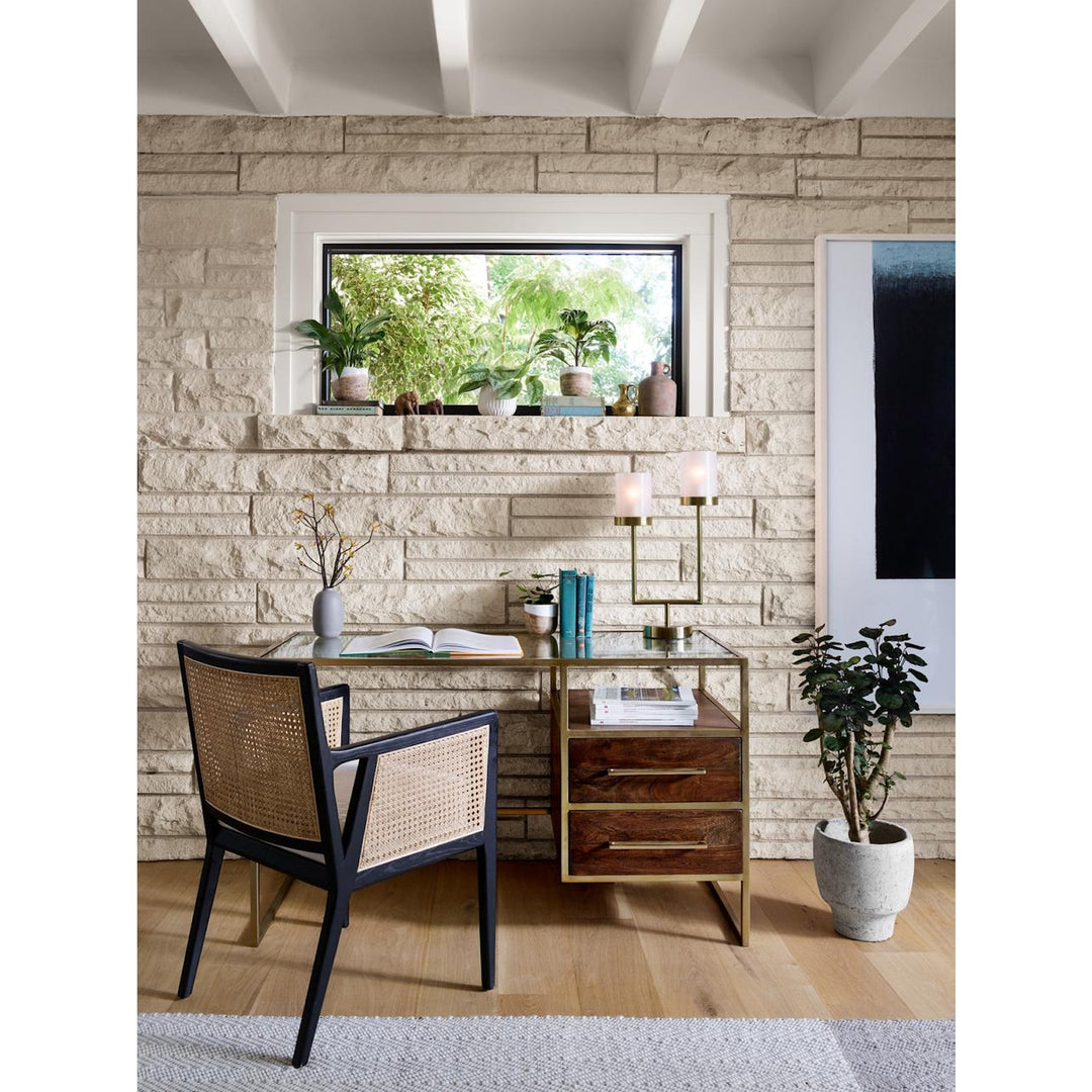 Rear view of the Antonia Cane Dining Arm Chair styled at a desk; other furniture and accessories not included