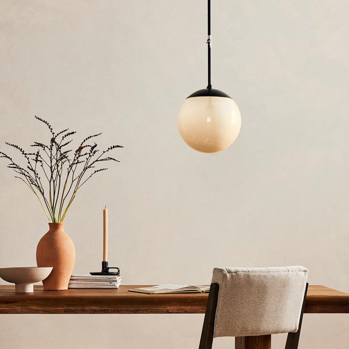 Sutton Small Pendant illuminated above a desk in a room setting; furniture and accessories not included