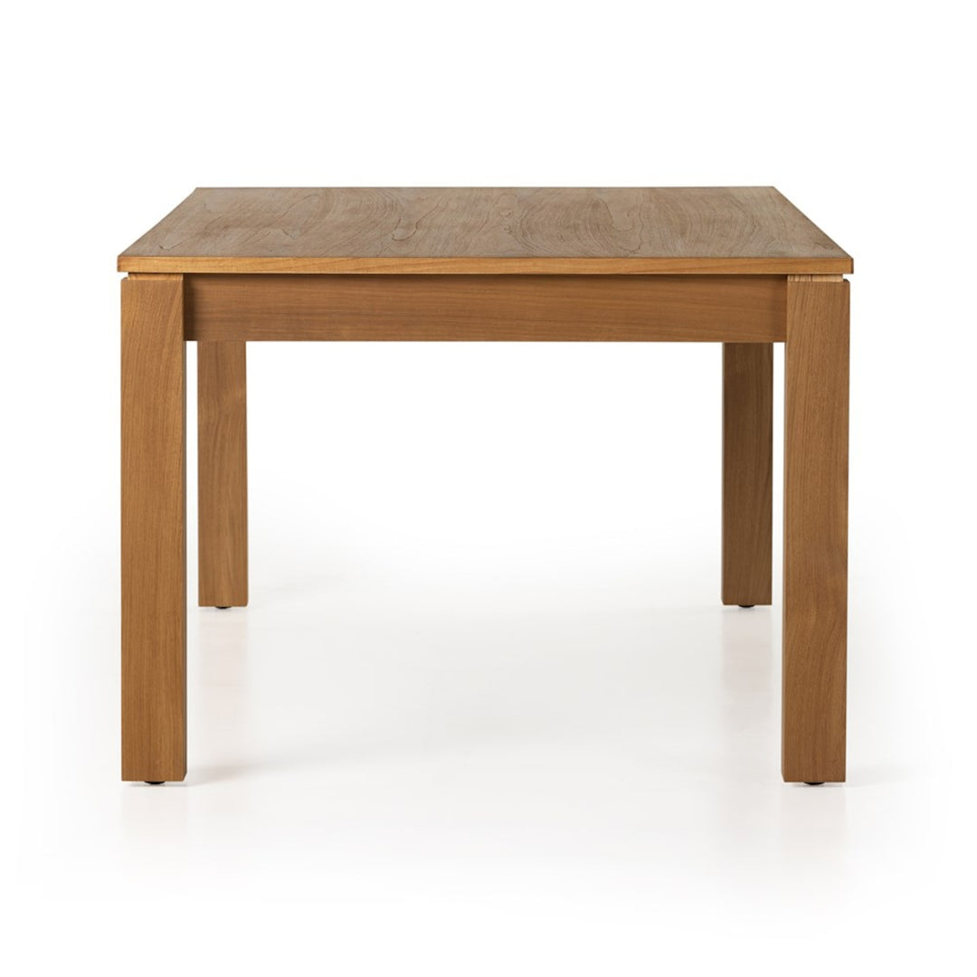 End view of the Timur dining table showing the natural teak veneer tabletop and legs