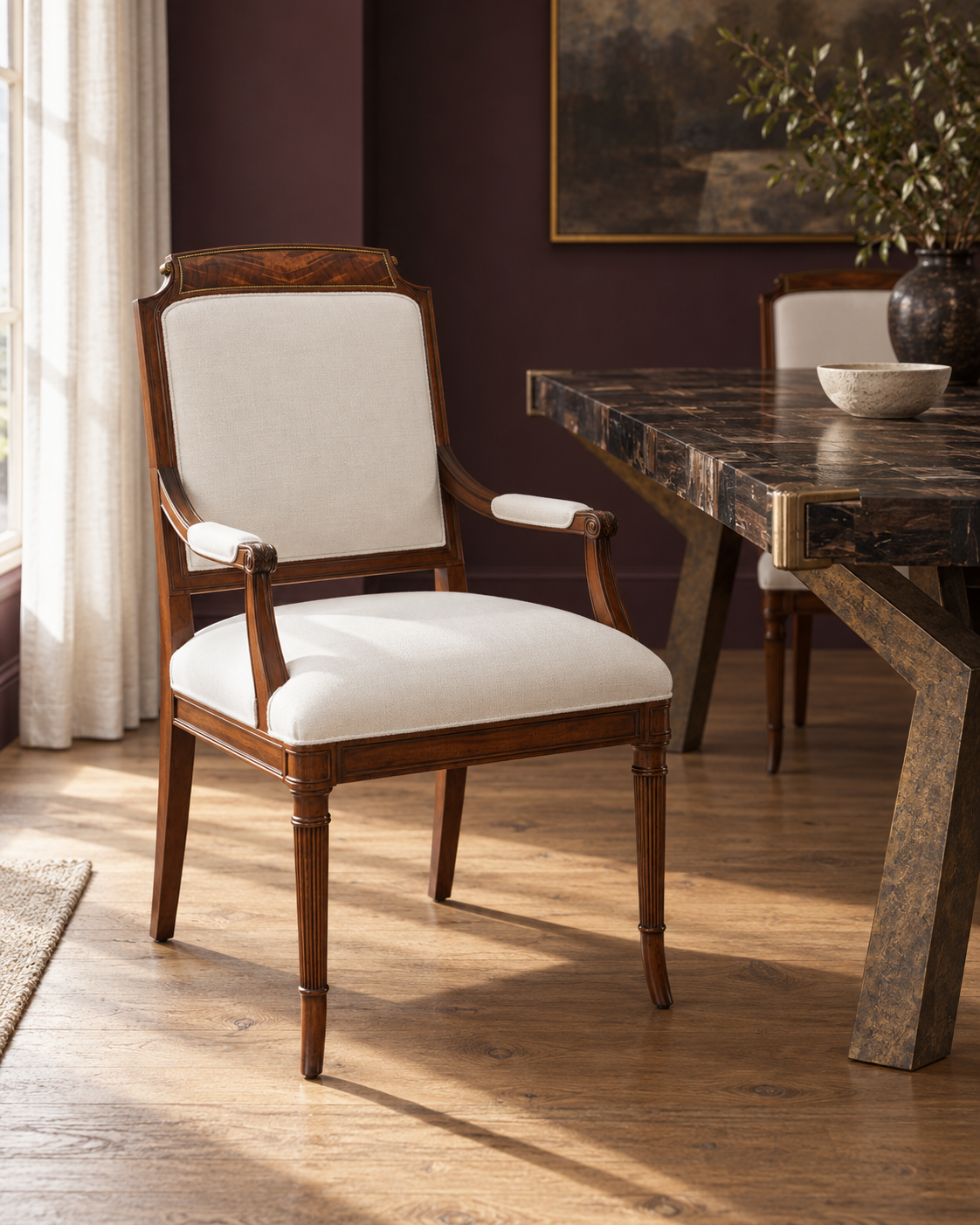 Theodore Alexander Atcombe dining chair beside Baker's Gibbon's Feast petrified wood table.