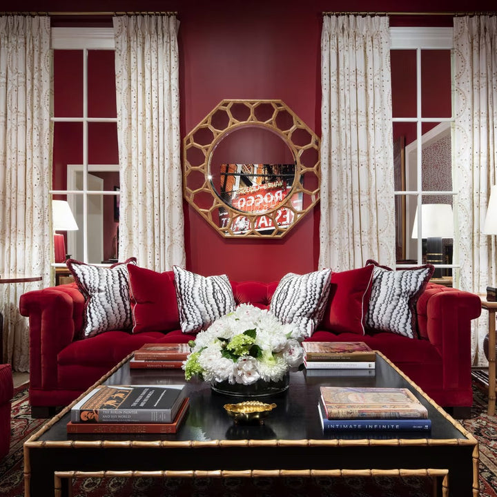 Luxurious living room with red walls, red sofa, and decorative elements.