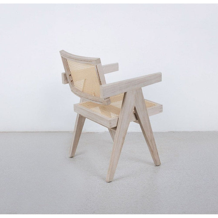 Alternate view of Jeanneret Armchair, featuring matte finish, solid wood, cane webbing, and fixed arms.