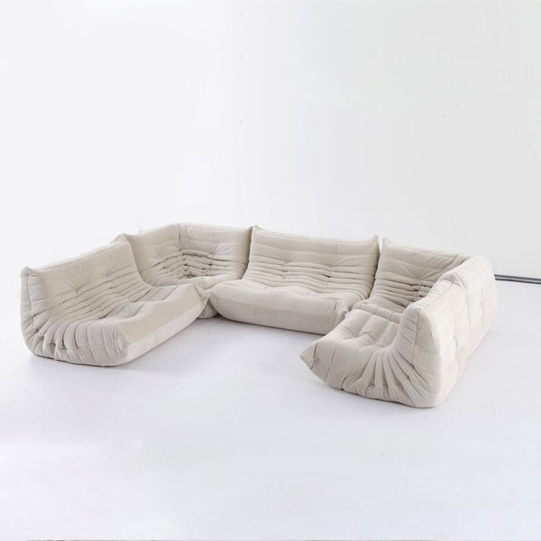 Channeled Lounger Modular Sectional, shown in ivory and off-white with velvet, fabric, and modular sectional configuration.
