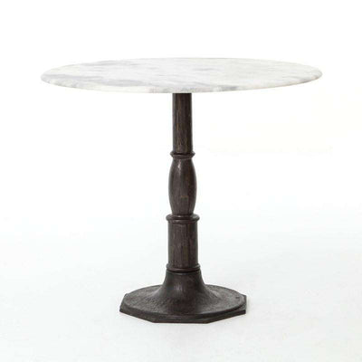 French-industrial meets bistro table. Detailed, 8-sided cast iron pedestal supports a dramatic white marble top with bull-nosed edge.
